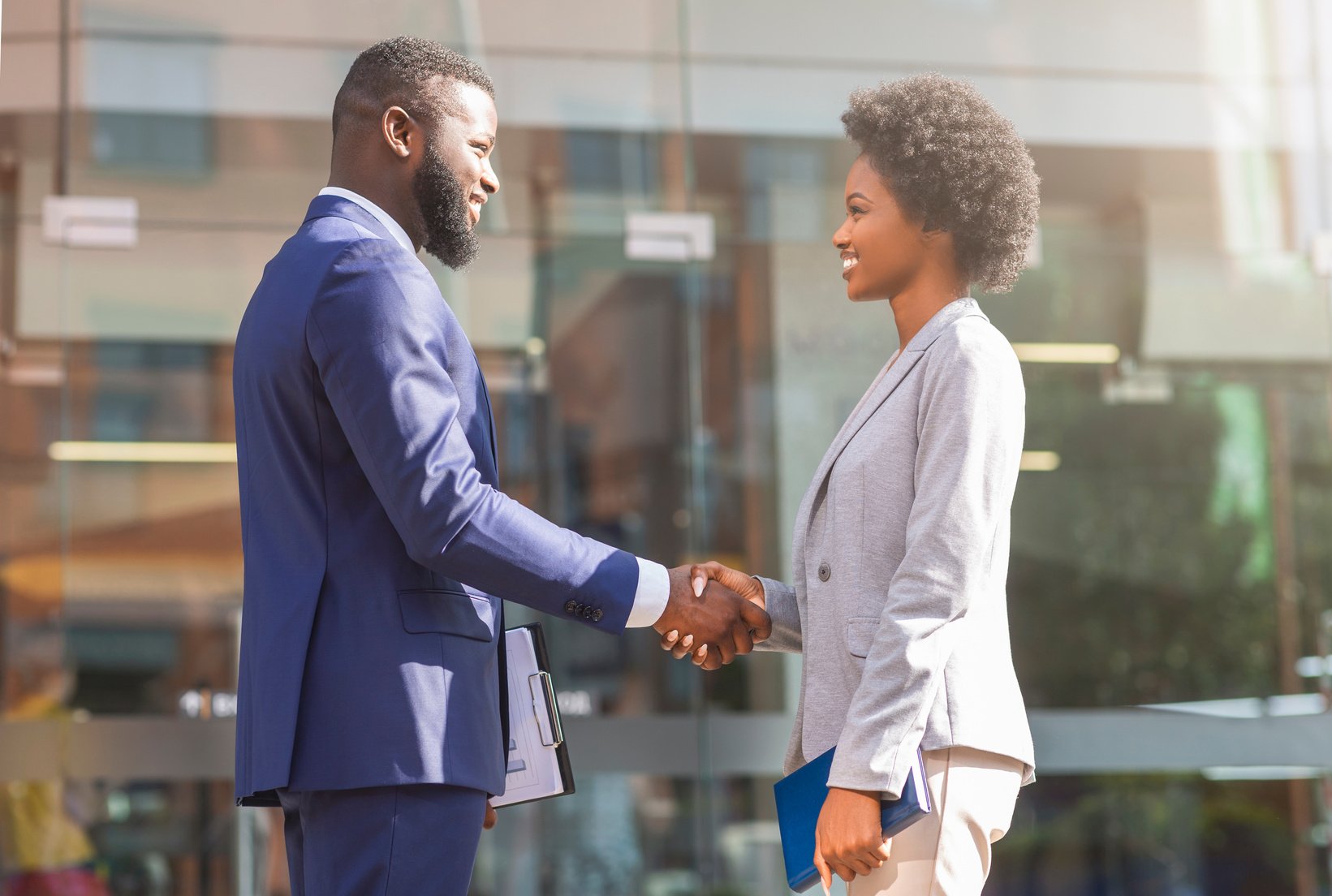 Young african business people shaking hands outdoors